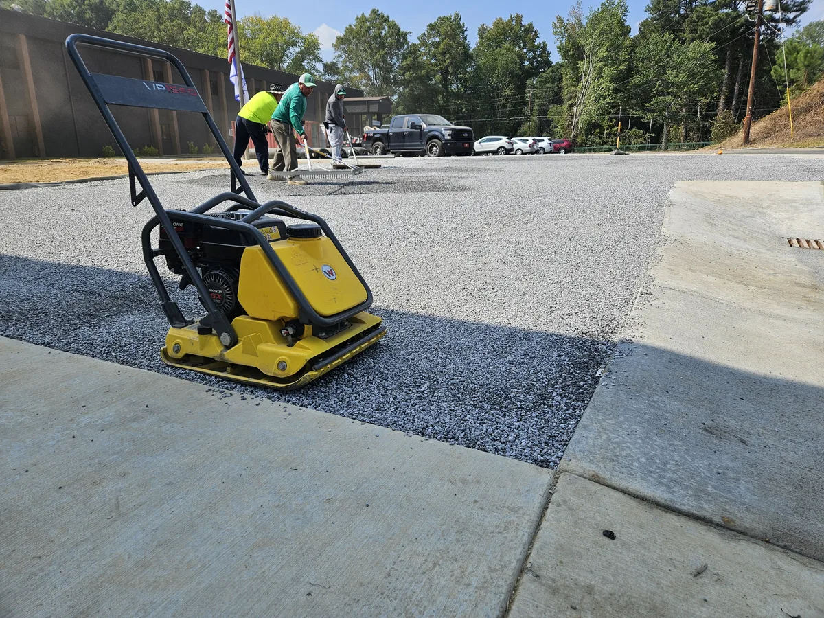 Gravel base being compacted before synthetic turf installation in Covington, GA