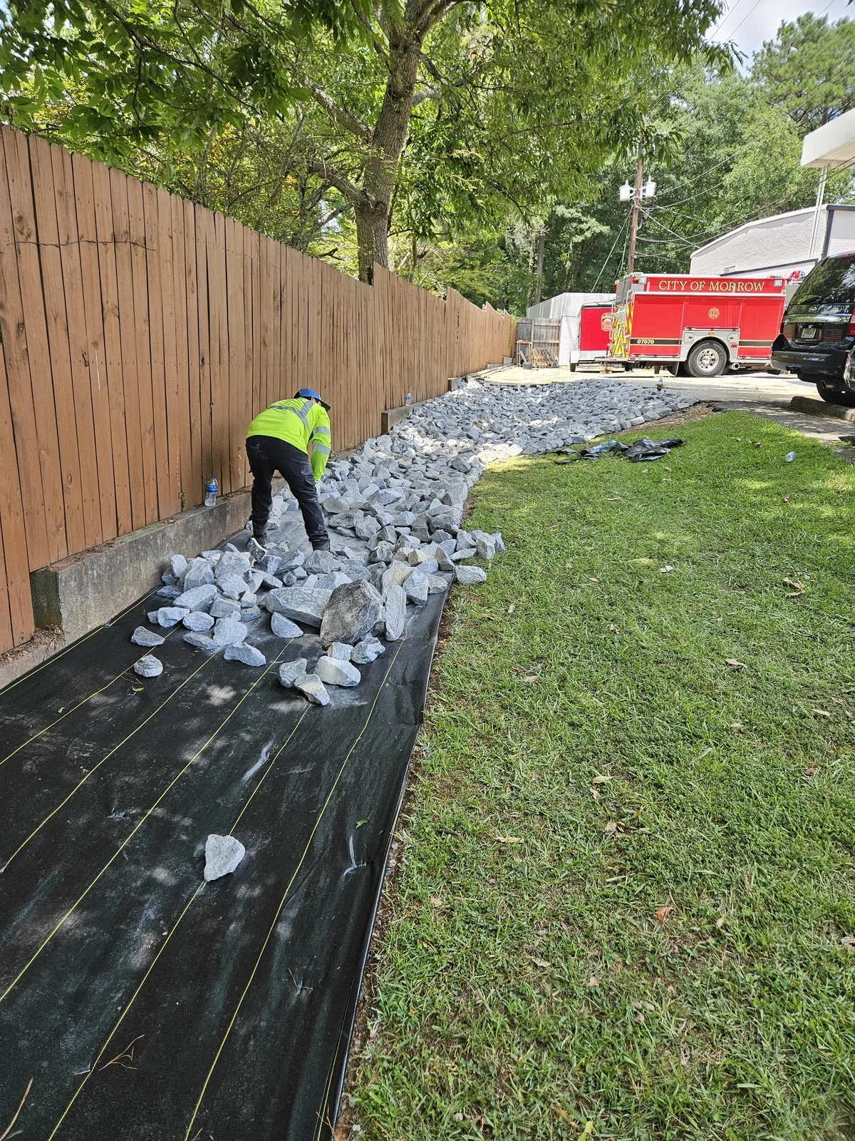 Rip-rap stone placement in progress during drainage installation in Newton County GA