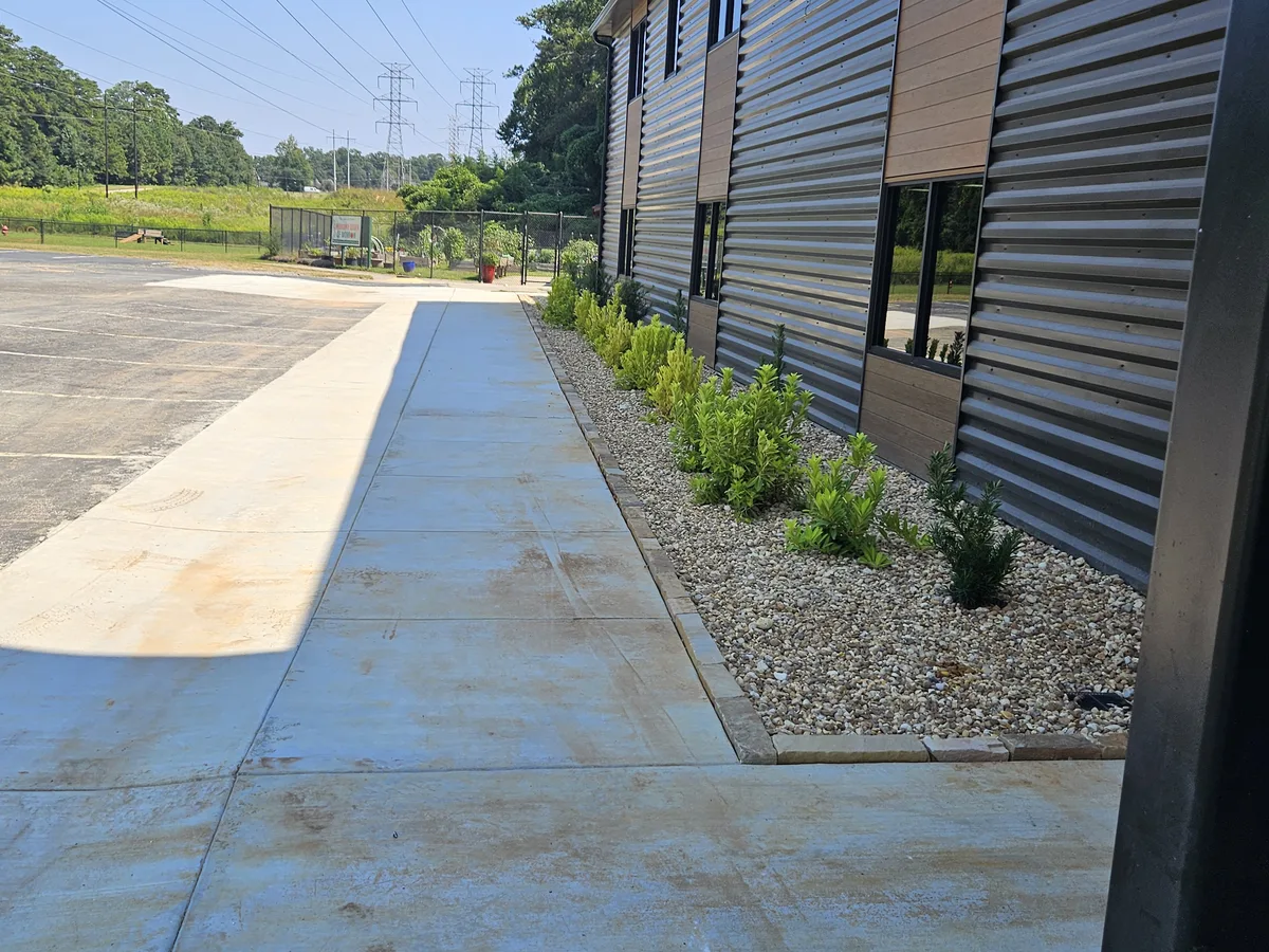 Stone-edged gravel bed along sidewalk in Newton County GA