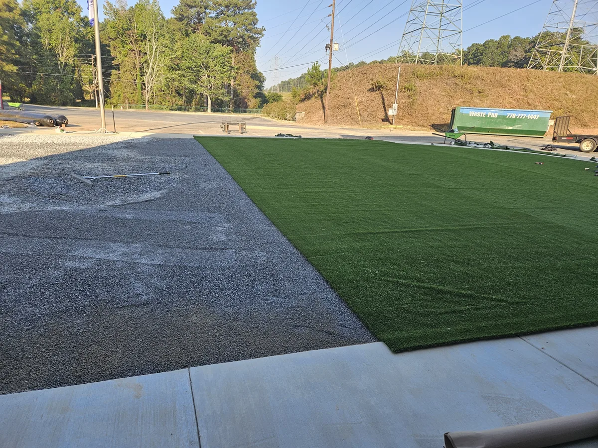 Liba Landscape crew laying synthetic turf rolls in Covington, GA